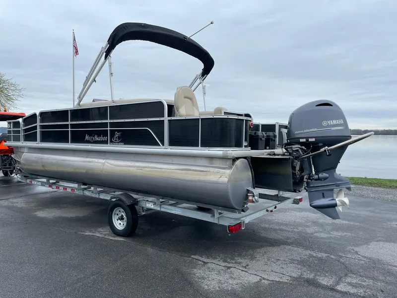 Slide: The Image of 2017 Misty Harbor 245 Adventure CC pontoon boat on trailer, with Yamaha outboard motor. - 3