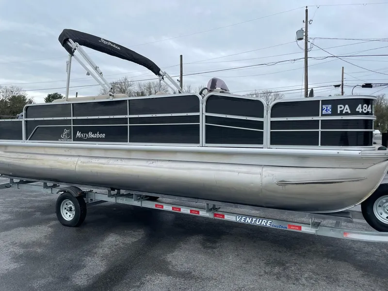 Slide: The Image of 2017 Misty Harbor 245 Adventure CC pontoon boat on a trailer, parked outdoors. - 7