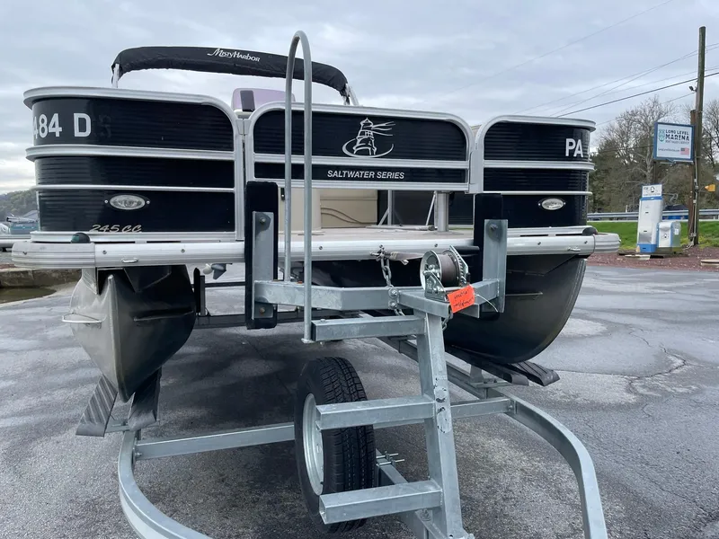 Slide: The Image of 2017 Misty Harbor 245 Adventure CC pontoon boat on trailer, parked outdoors. - 8