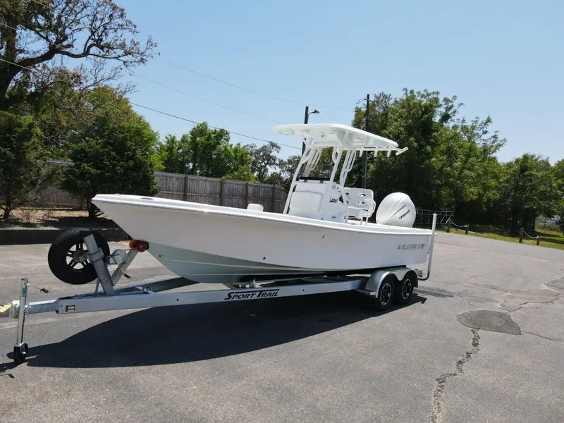 Slide: The Image of 2025 Blazer Bay 2440 boat on trailer in sunny outdoor setting. - 1