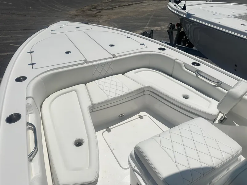 Slide: The Image of 2025 Blazer Bay 2440 boat interior with white cushioned seating. - 10