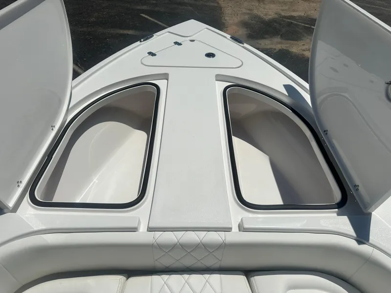 Slide: The Image of 2025 Blazer Bay 2440 boat storage compartments with open hatches, showcasing spacious design. - 12