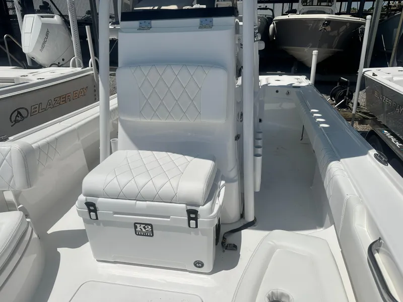 Slide: The Image of 2025 Blazer Bay 2440 boat interior with white seating and K2 cooler. - 13