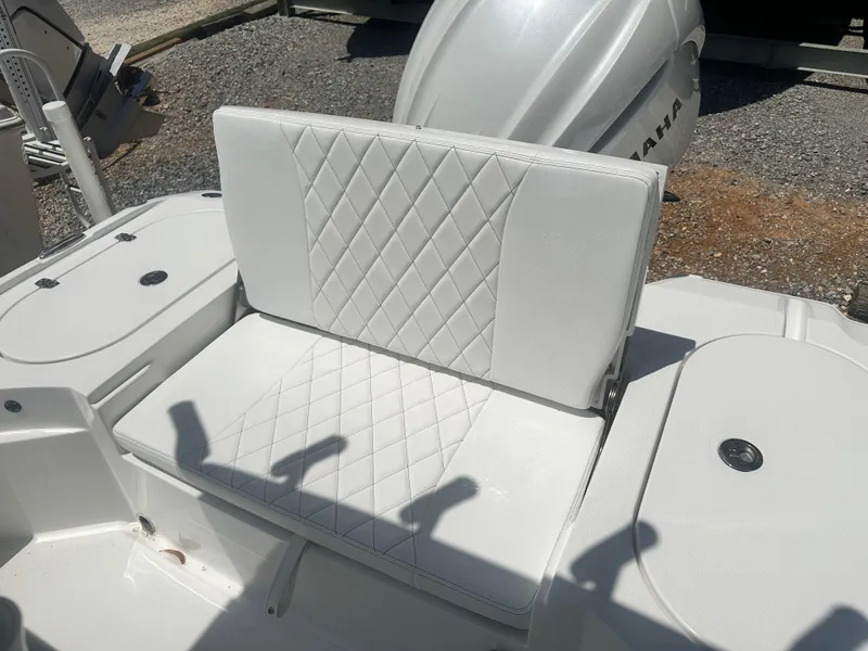 Slide: The Image of 2025 Blazer Bay 2440 boat seat with diamond-stitched white upholstery, Yamaha engine visible. - 15