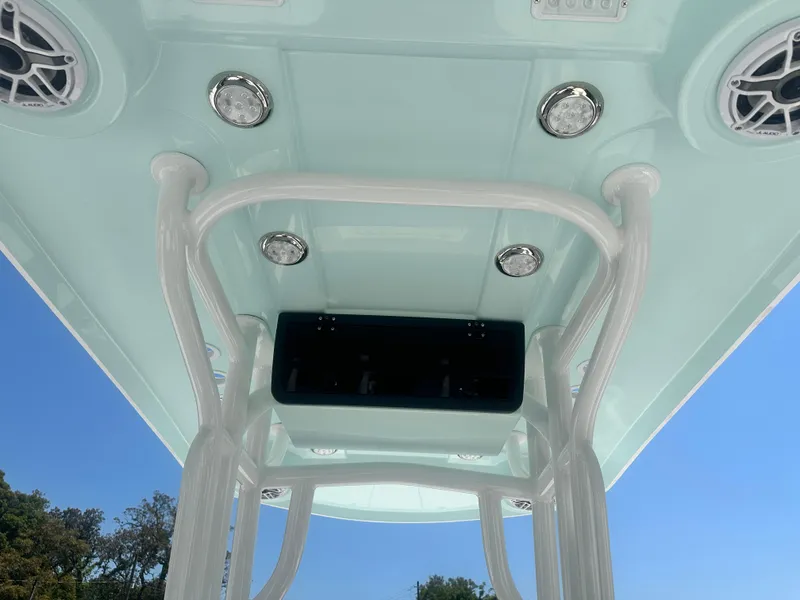 Slide: The Image of T-top of 2025 Blazer Bay 2440 boat with speakers and lights, viewed from below. - 16