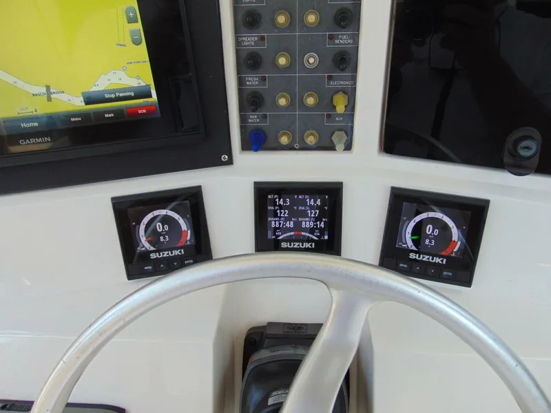 Slide: The Image of Control panel of a 2002 Jupiter 27 Open boat with Suzuki gauges and Garmin GPS. - 12