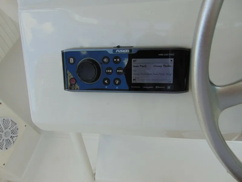 Slide: The Image of Fusion marine stereo on a 2002 Jupiter 27 Open boat dashboard. - 13