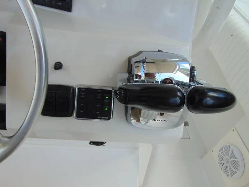 Slide: The Image of Control panel of a 2002 Jupiter 27 Open boat with Suzuki throttle levers. - 14