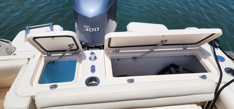 Slide: The Image of 2017 Grady-White Freedom 235 boat with open storage compartments and Yamaha 300 engine. - 15