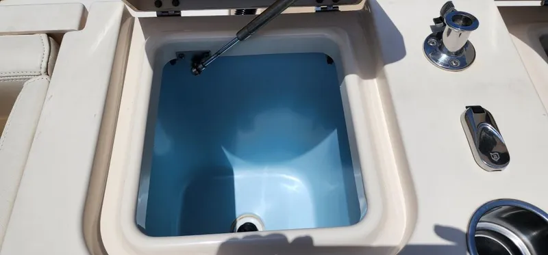 Slide: The Image of 2017 Grady-White Freedom 235 boat livewell with open lid and stainless steel fittings. - 16