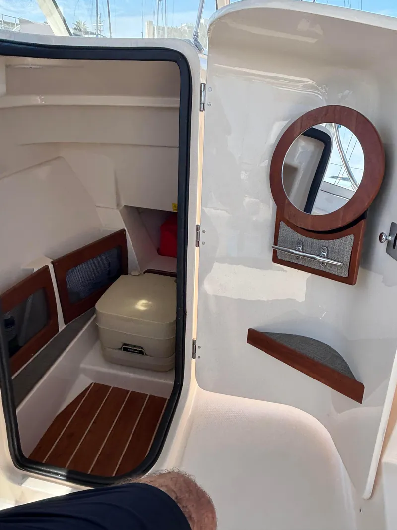 Slide: The Image of 2017 Grady-White Freedom 235 boat interior with cabin and mirror. - 18