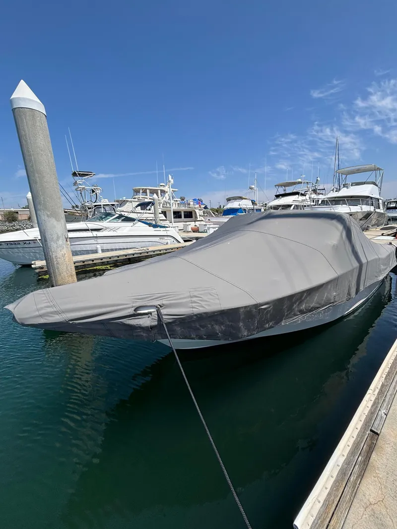 Slide: The Image of 2017 Grady-White Freedom 235 boat covered and docked in a marina. - 23