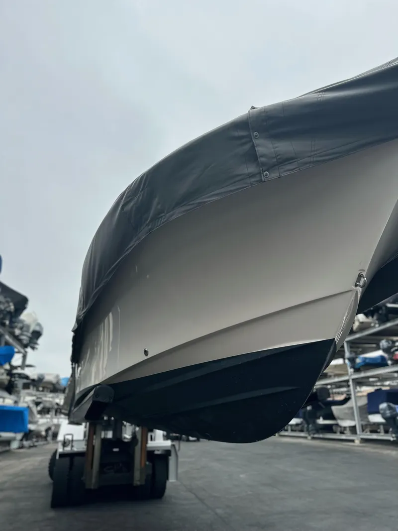 Slide: The Image of 2017 Grady-White Freedom 235 boat covered and elevated in storage facility. - 26