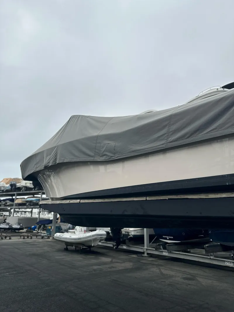 Slide: The Image of 2017 Grady-White Freedom 235 boat covered and stored on a trailer at a marina. - 27