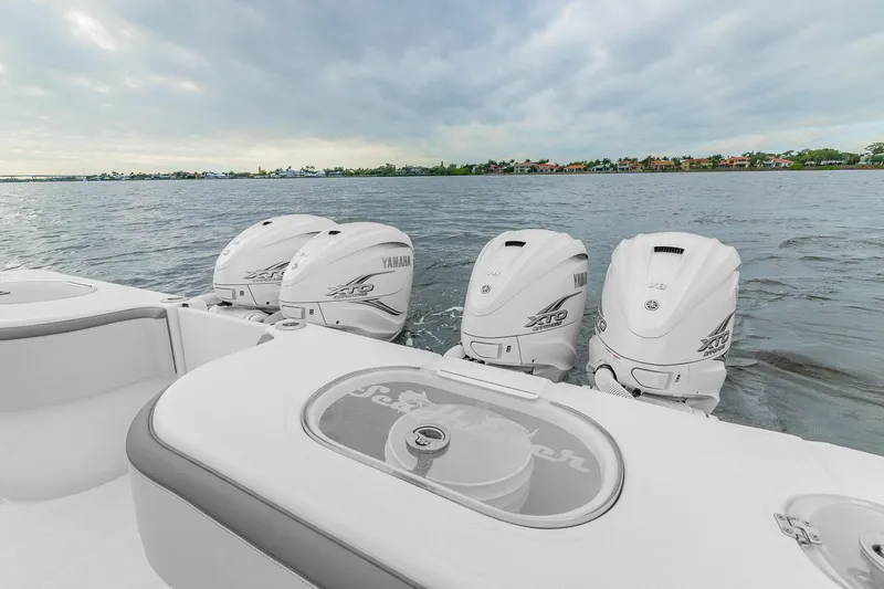 Slide: The Image of 2022 SeaHunter 41 CTS boat with four powerful outboard engines on a calm water backdrop. - 11