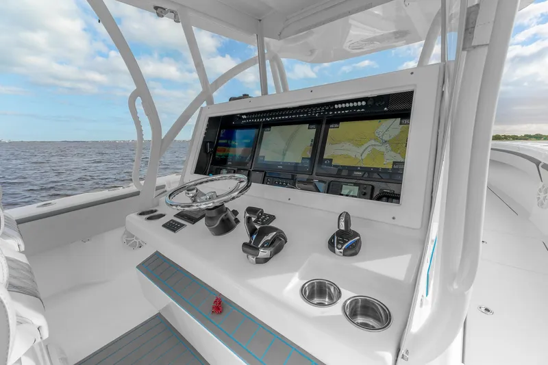 Slide: The Image of 2022 SeaHunter 41 CTS boat cockpit with advanced navigation system and ocean view. - 14