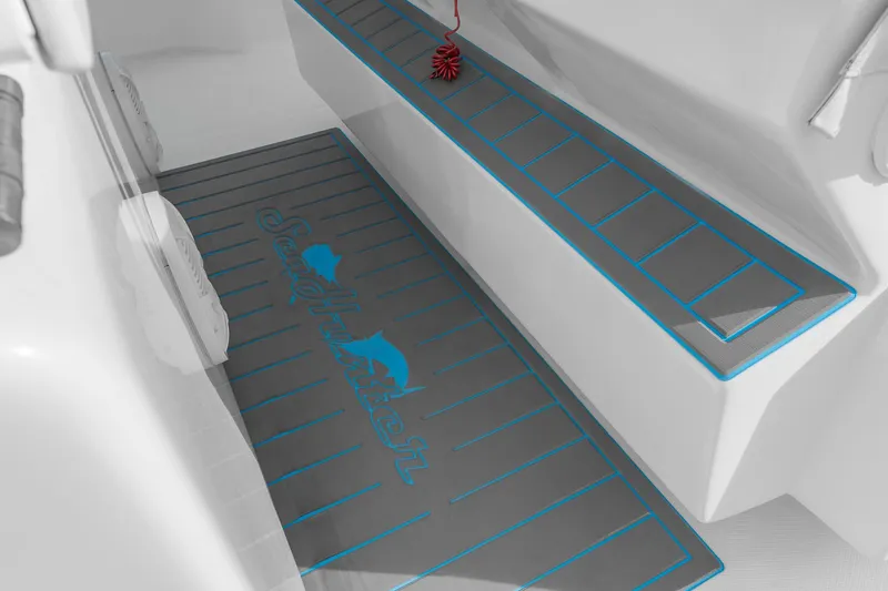 Slide: The Image of 2022 SeaHunter 41 CTS boat interior with custom blue-trimmed flooring and seating. - 15