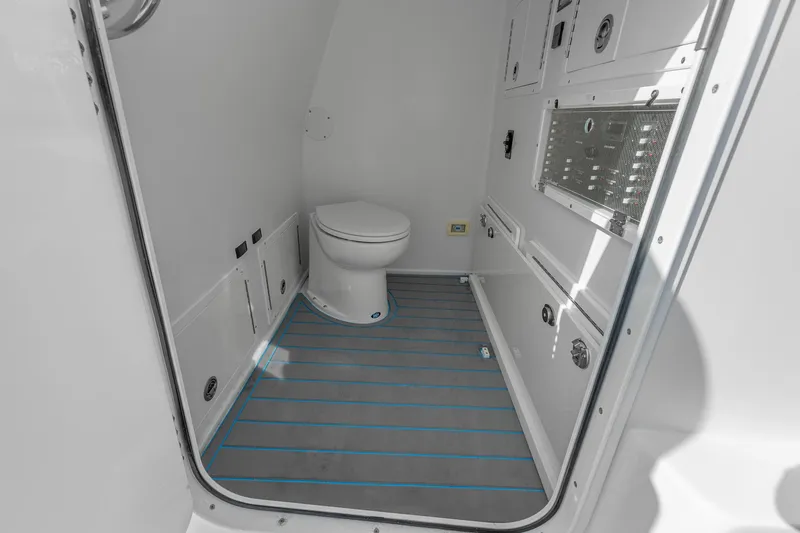 Slide: The Image of 2022 SeaHunter 41 CTS boat interior bathroom with modern toilet and sleek design. - 16