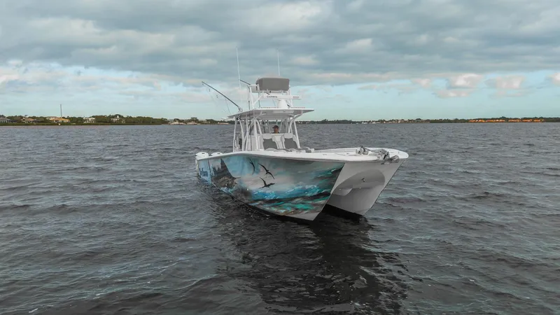 Slide: The Image of 2022 SeaHunter 41 CTS boat on open water under cloudy sky. - 4