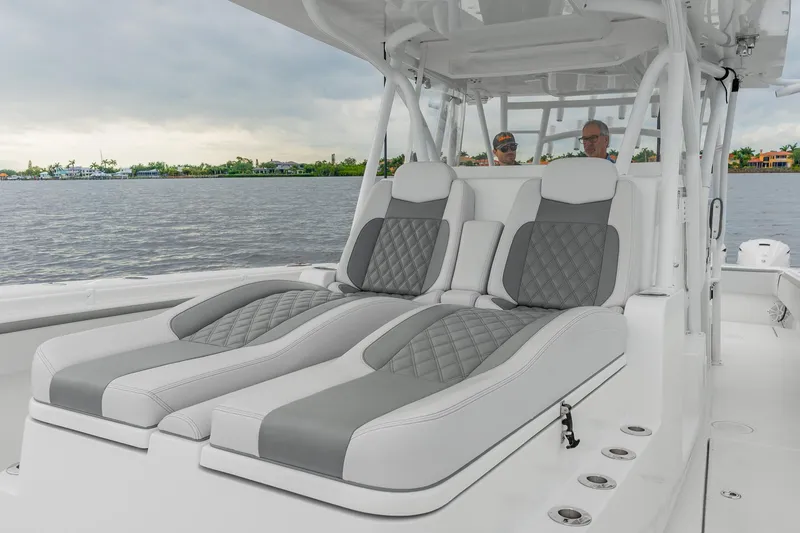 Slide: The Image of 2022 SeaHunter 41 CTS boat with luxurious gray and white seating on a calm water backdrop. - 7