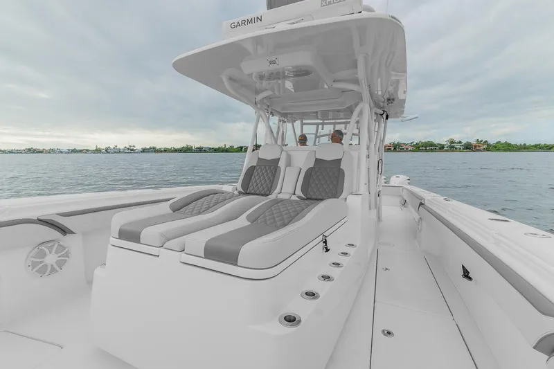 Slide: The Image of 2022 SeaHunter 41 CTS boat with sleek seating and open deck on calm water. - 8