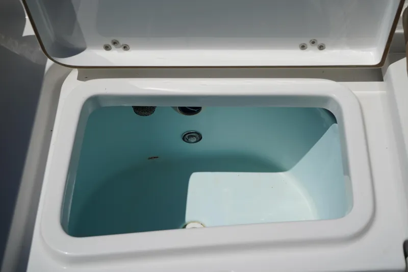 Slide: The Image of Livewell compartment on a 2016 Sportsman Heritage 211 Center Console boat. - 10