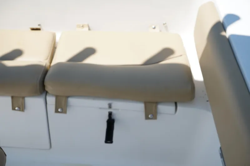 Slide: The Image of 2016 Sportsman Heritage 211 Center Console boat seats with beige cushions. - 11