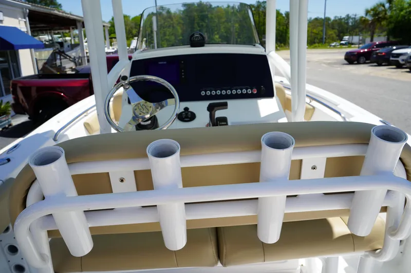 Slide: The Image of 2016 Sportsman Heritage 211 Center Console boat interior with rod holders and steering wheel. - 12