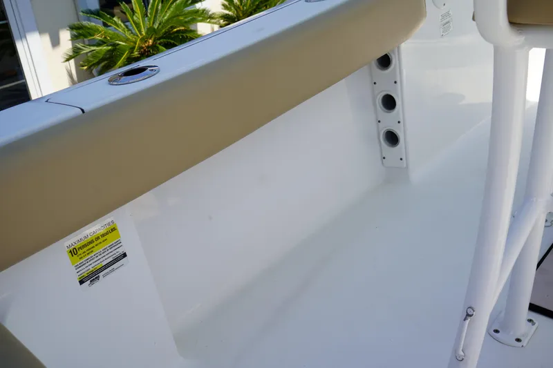 Slide: The Image of 2016 Sportsman Heritage 211 Center Console interior with rod holders and seating. - 13