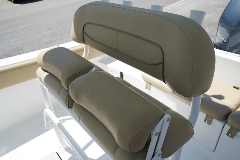 Slide: The Image of 2016 Sportsman Heritage 211 Center Console boat seating, beige upholstery, white frame. - 16