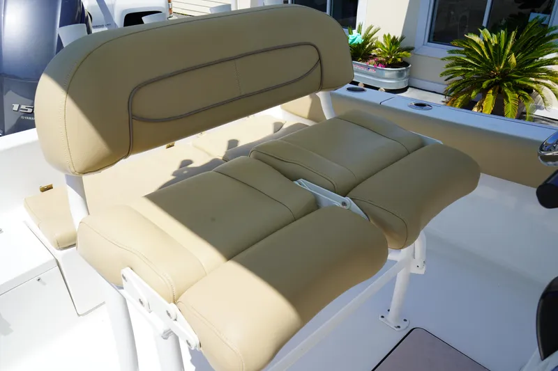 Slide: The Image of 2016 Sportsman Heritage 211 Center Console boat seat, beige upholstery, outdoor setting. - 17
