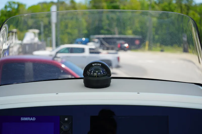 Slide: The Image of 2016 Sportsman Heritage 211 Center Console dashboard with Ritchie compass and Simrad display. - 23