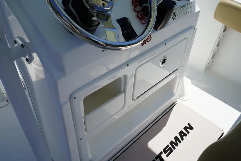 Slide: The Image of 2016 Sportsman Heritage 211 Center Console dashboard with steering wheel and storage compartments. - 25