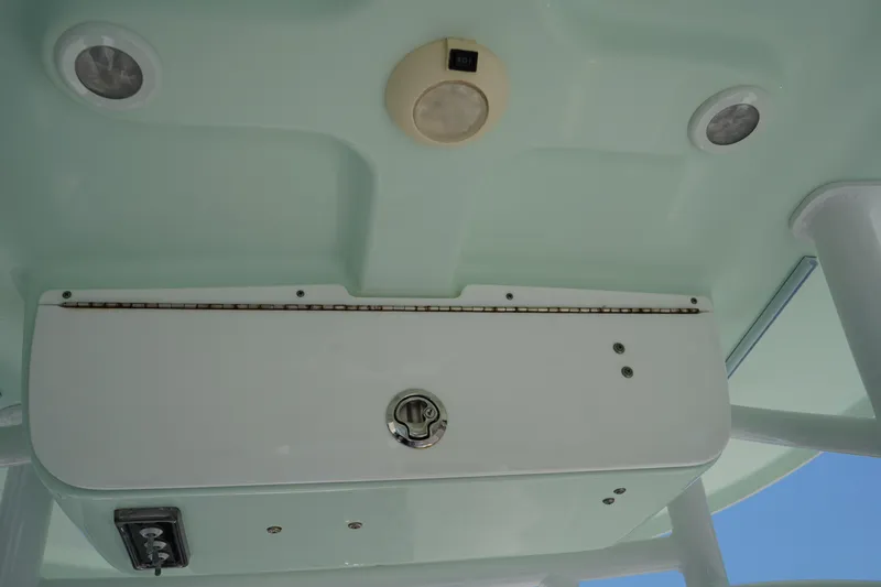 Slide: The Image of 2016 Sportsman Heritage 211 Center Console boat interior ceiling with lights and storage compartment. - 26
