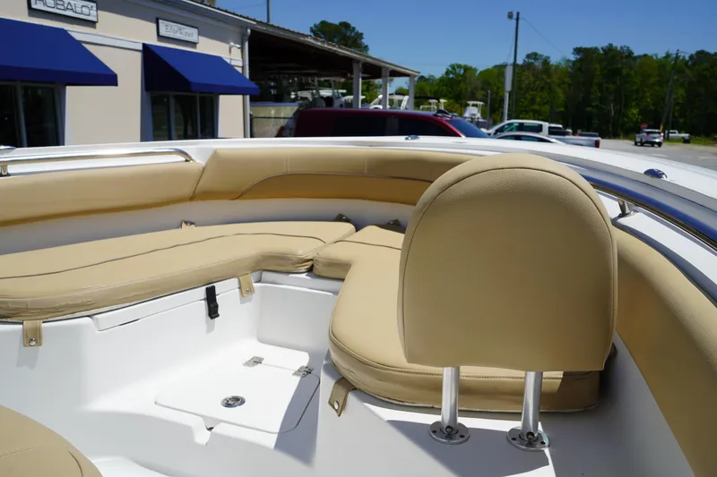 Slide: The Image of 2016 Sportsman Heritage 211 Center Console boat interior with beige seating. - 32