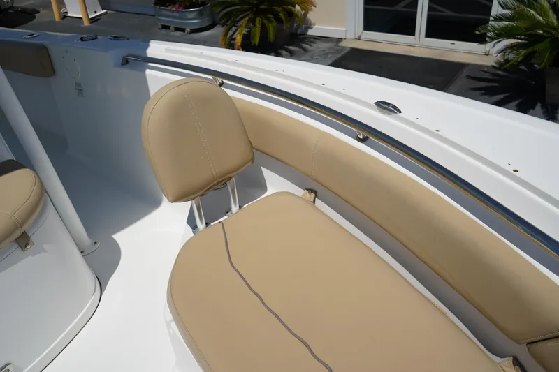 Slide: The Image of 2016 Sportsman Heritage 211 Center Console boat interior with beige seating. - 36