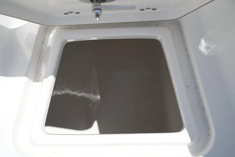 Slide: The Image of Open storage compartment on 2016 Sportsman Heritage 211 Center Console boat. - 38