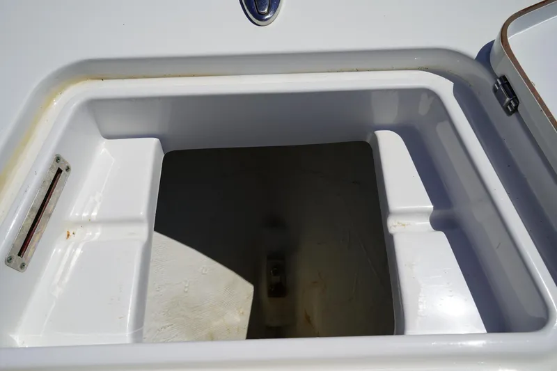 Slide: The Image of Open storage compartment on 2016 Sportsman Heritage 211 Center Console boat. - 40