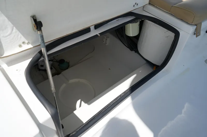Slide: The Image of Open storage compartment on 2016 Sportsman Heritage 211 Center Console boat. - 8