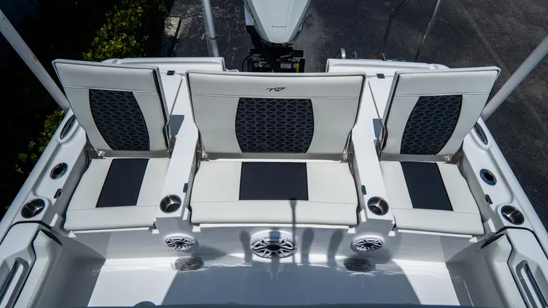 Slide: The Image of 2025 Tidewater 2500 Carolina Bay boat seating area with stylish white and black upholstery. - 10