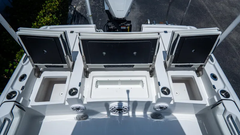 Slide: The Image of 2025 Tidewater 2500 Carolina Bay boat deck with storage compartments and speakers. - 11