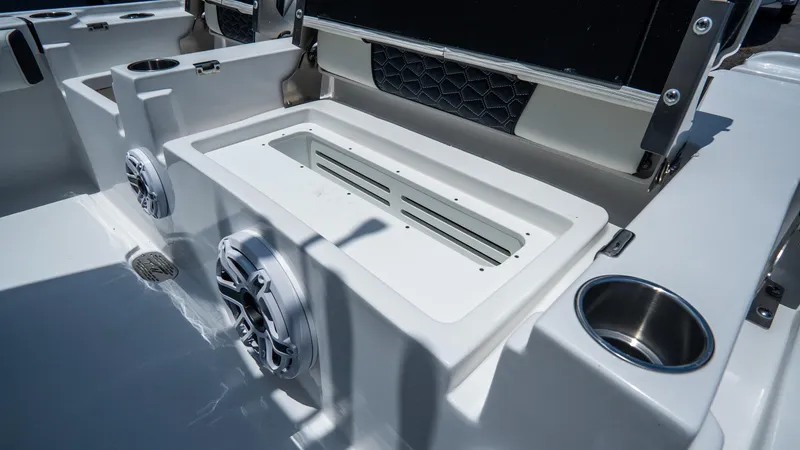 Slide: The Image of 2025 Tidewater 2500 Carolina Bay boat interior with speakers and cup holders. - 12