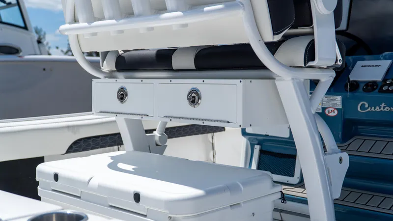 Slide: The Image of 2025 Tidewater 2500 Carolina Bay boat interior with seating and storage compartments. - 13