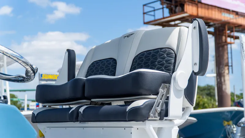 Slide: The Image of 2025 Tidewater 2500 Carolina Bay boat seats, featuring sleek black and white design under a clear sky. - 14