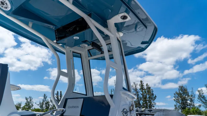 Slide: The Image of 2025 Tidewater 2500 Carolina Bay boat with Garmin equipment, under a clear blue sky. - 17