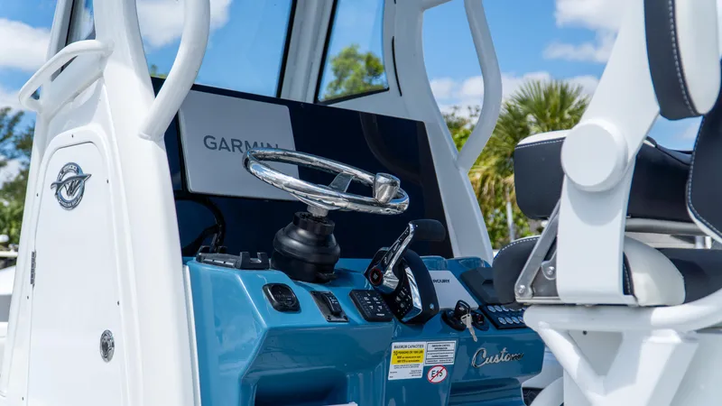 Slide: The Image of 2025 Tidewater 2500 Carolina Bay boat dashboard with Garmin navigation system. - 18
