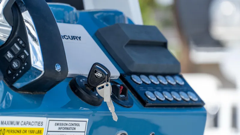 Slide: The Image of Control panel of 2025 Tidewater 2500 Carolina Bay boat with ignition keys. - 19