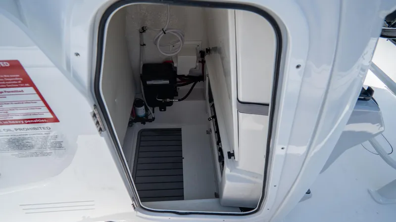 Slide: The Image of 2025 Tidewater 2500 Carolina Bay storage compartment with equipment and clean interior. - 21
