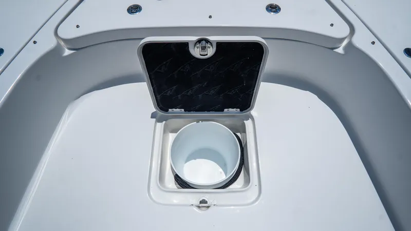Slide: The Image of 2025 Tidewater 2500 Carolina Bay boat storage compartment with open hatch. - 28