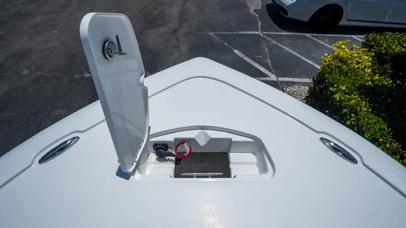 Slide: The Image of 2025 Tidewater 2500 Carolina Bay boat with open storage compartment on deck. - 29